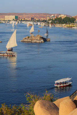 Beautiful landscape with felucca boats on Nile river in Aswan at sunset, Egypt